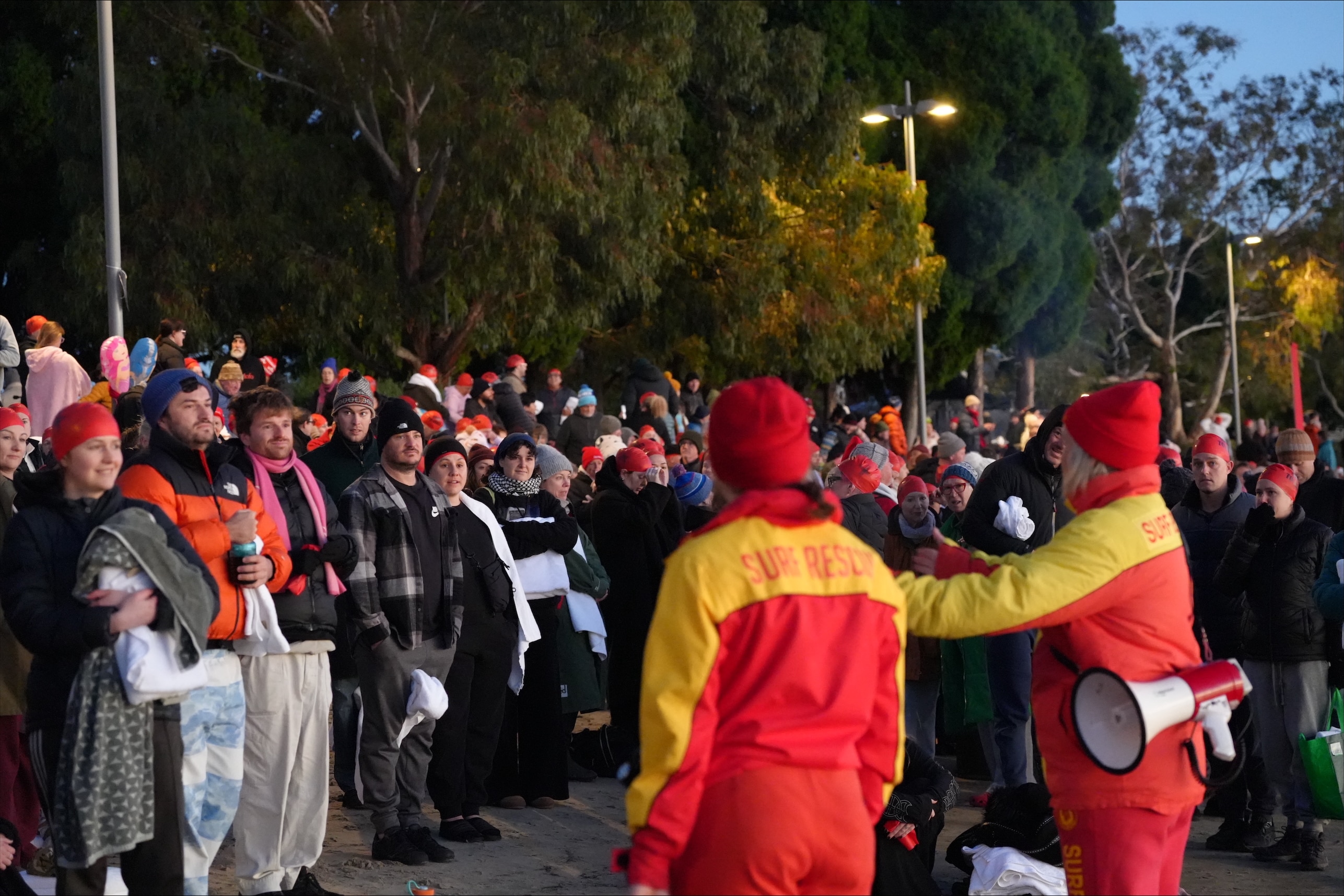 Crowd of swimmers prepare to enter the water for Dark Mofo's 2026 Nude Solstice Swim