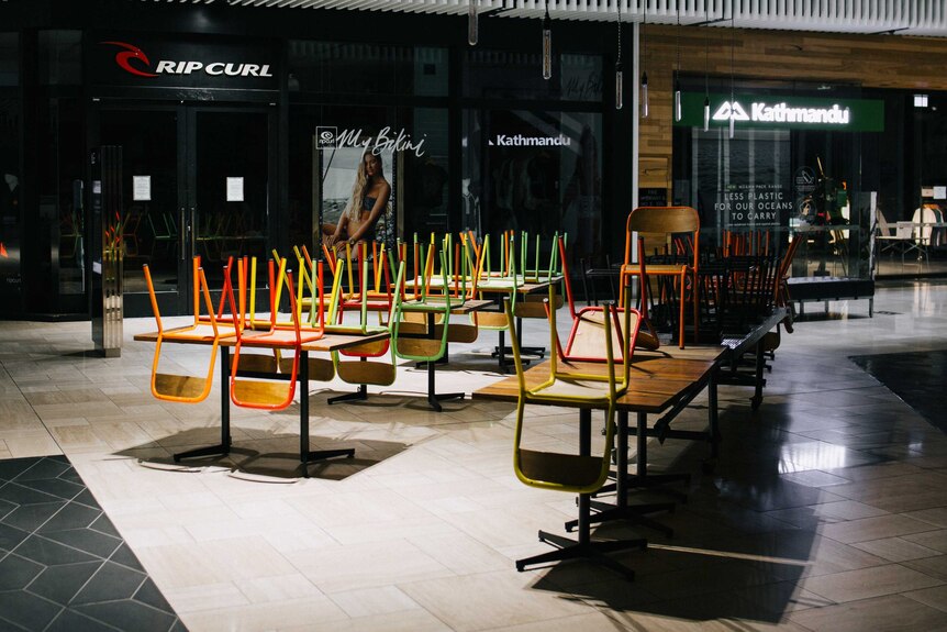 A photo of chairs up on tables in a Melbourne shopping centre eatery.