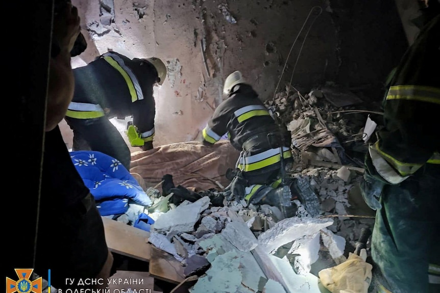 emergency workers dig through debris after a missile strike in Odesa, Ukraine