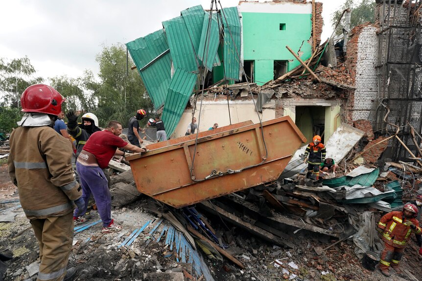 Rescuers remove debris after a Russian missile attack in Kharkiv, Ukraine