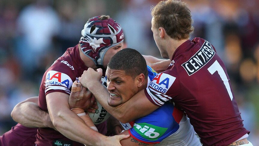 Brick wall ... Willie Mason is met by Manly's solid defensive line