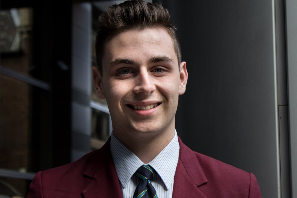 A teenage boy in school uniform