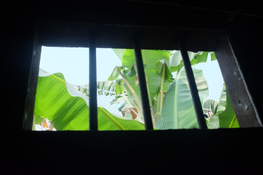 Looking through a window from inside a reconstructed Myanmar jail cell.