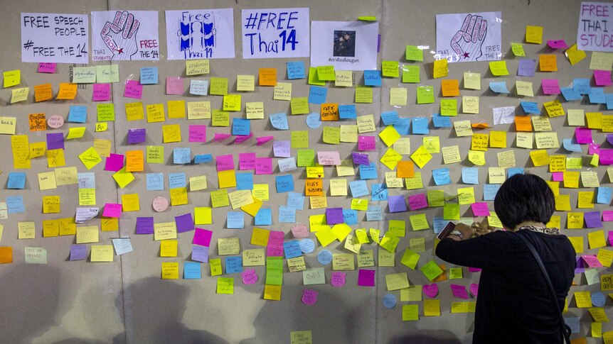 A woman posts a message to show support for 14 students who have been arrested in Thailand, July 3, 2015.