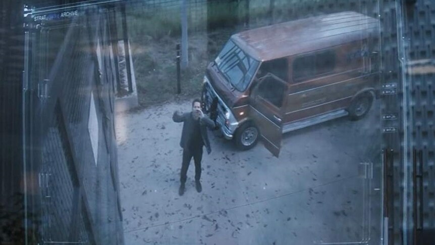 Scott Lang yelling at the doorbell of the Avengers complex, standing next to an orange van.