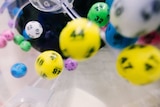 Numbered lottery balls mid-air.