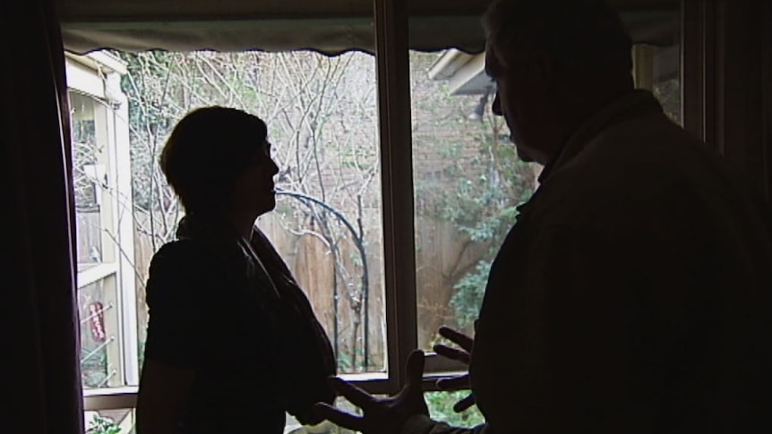 Silhouettes of a man and a woman arguing.