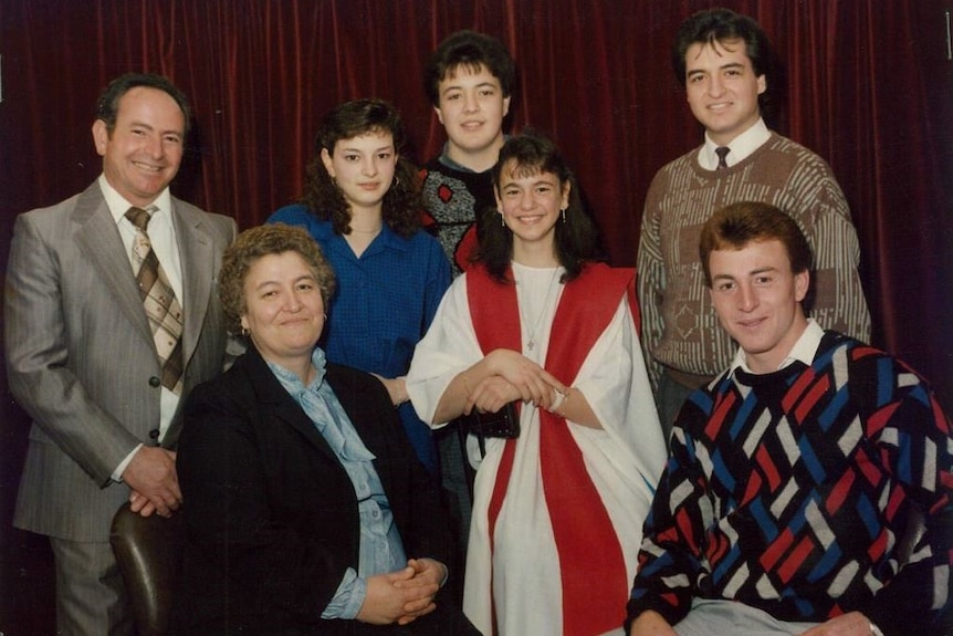 Salvatore Rotiroti with his wife and three daughters and two sons pose for a family photogaph.