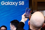 A man examines a Samsung Galaxy S8