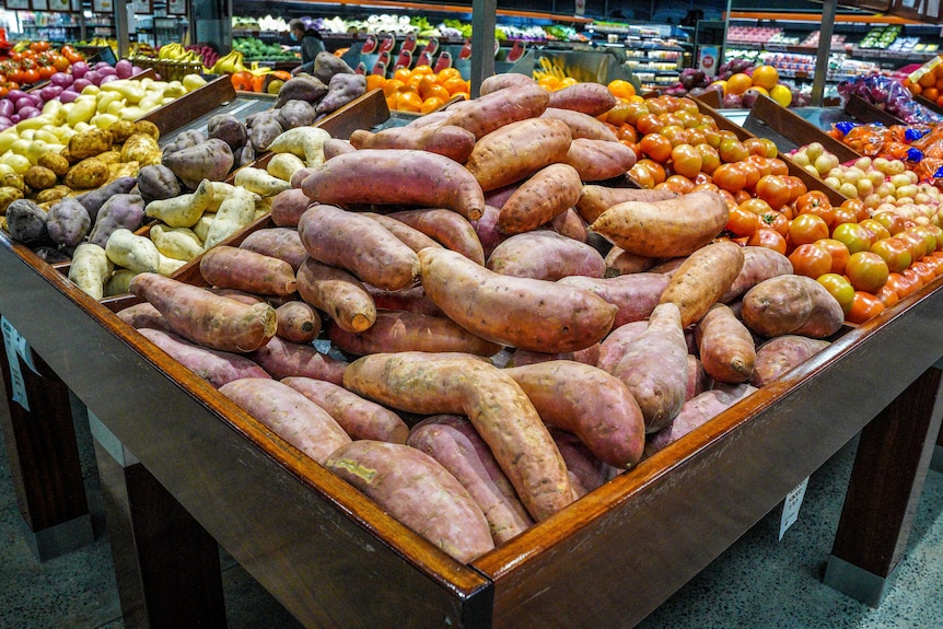 Attractive display of fresh vegetables and fruit in grocery store