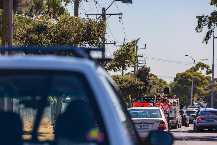 A line of traffic can be seen on a local road