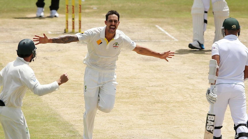 Australia's Mitchell Johnson celebrates after taking the wicket of South Africa's Alviro Petersen.