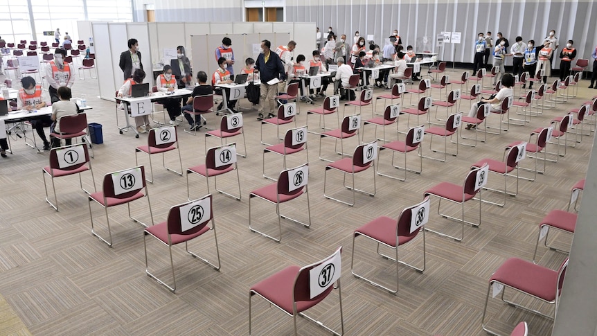 Rows of empty chairs at large-scale vaccination centre in Osaka 