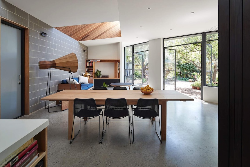 A dining room table with six chairs.