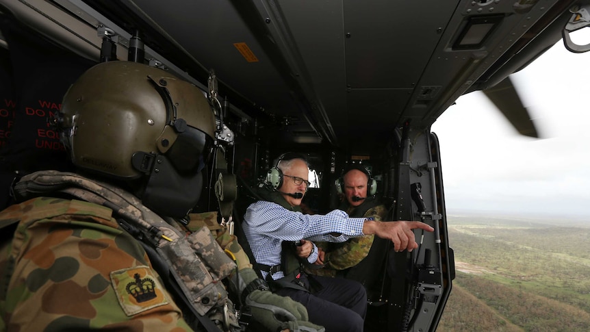Prime Minister Malcolm Turnbull looks at the devastation from a helicopter.