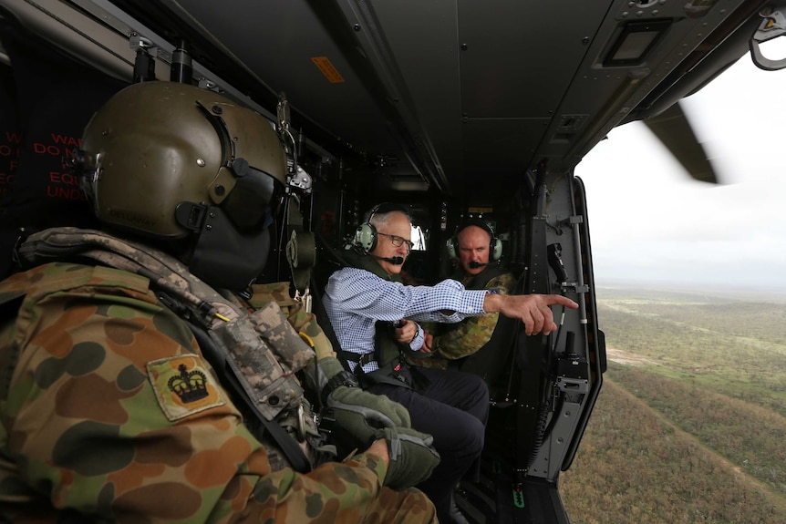 Prime Minister Malcolm Turnbull looks at the devastation from a helicopter.