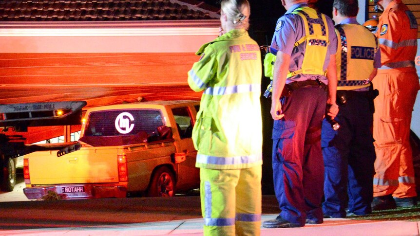 Emergency services officers at the scene where a car crashed into a house in Hillarys.