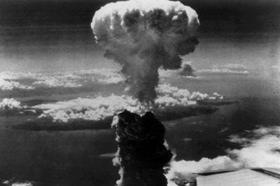 A mushroom cloud rises above Nagasaki after an atomic bomb was dropped.