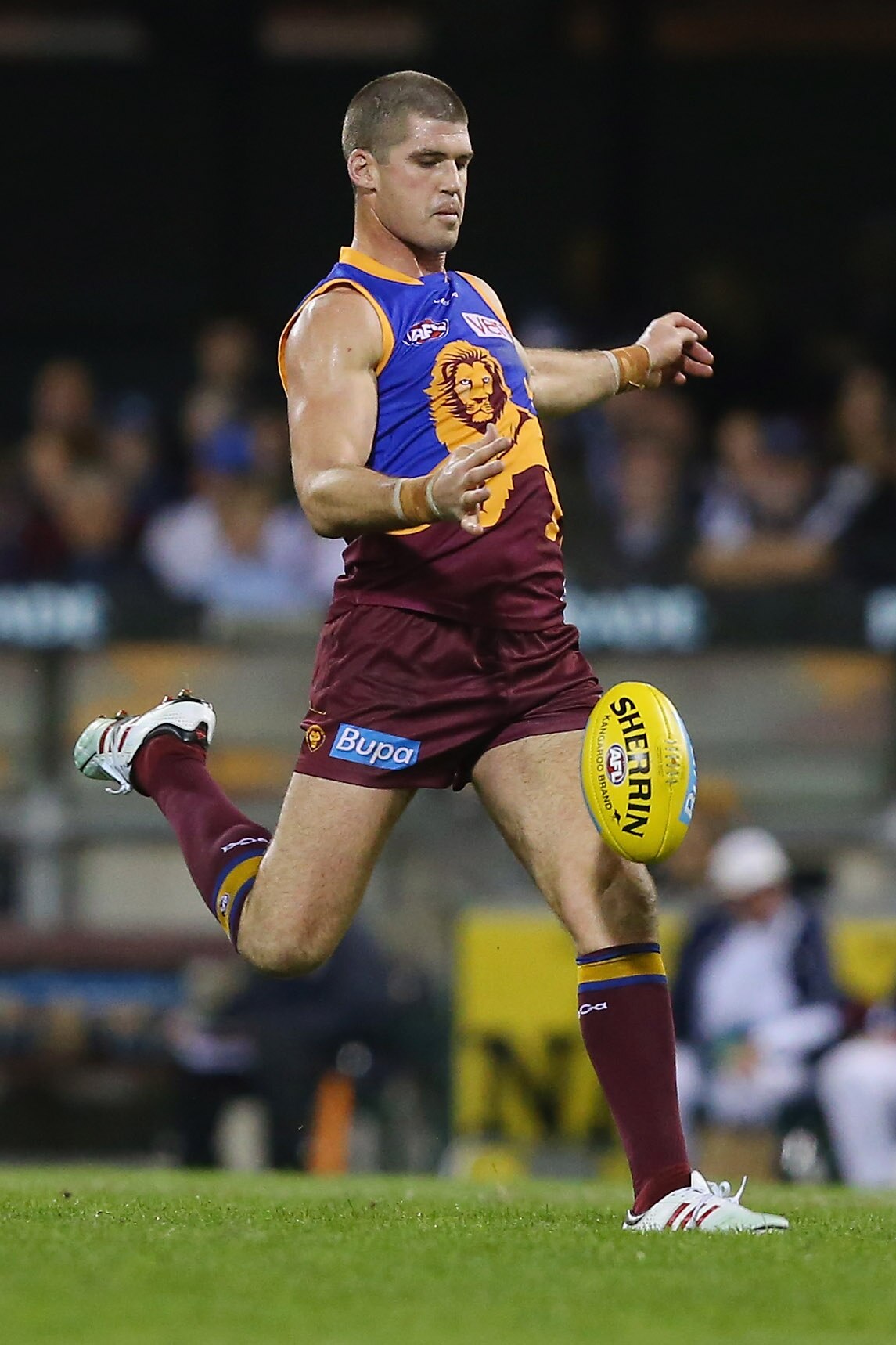 Brisbane Lions AFL forward Jonathan Brown drops the ball for a kick for goal during a game.