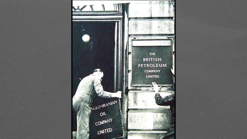 Two men put up signs for the British Petroleum Company