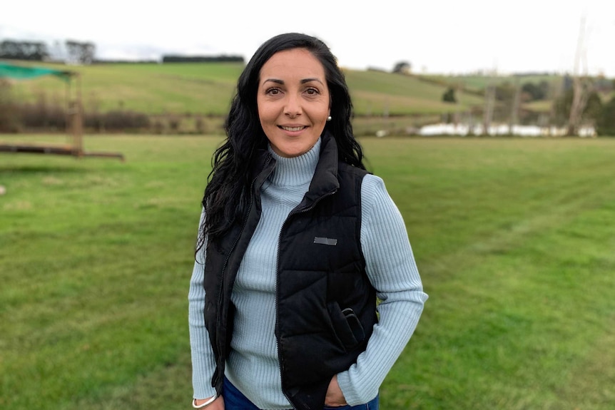 Emma Germano stands in a green field.