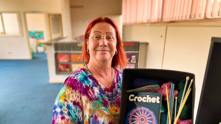 Raelene Wlochowicz holds a box of arts and crafts