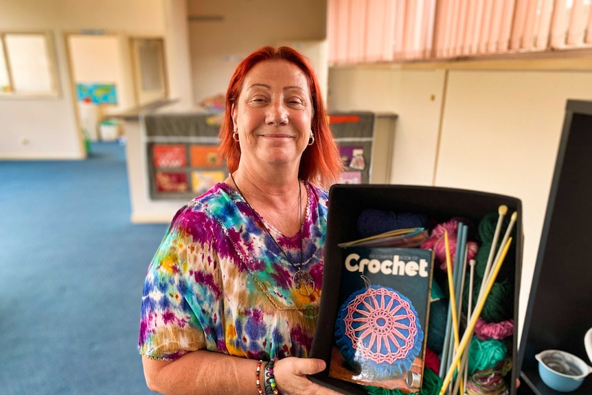 Raelene Wlochowicz holds a box of arts and crafts