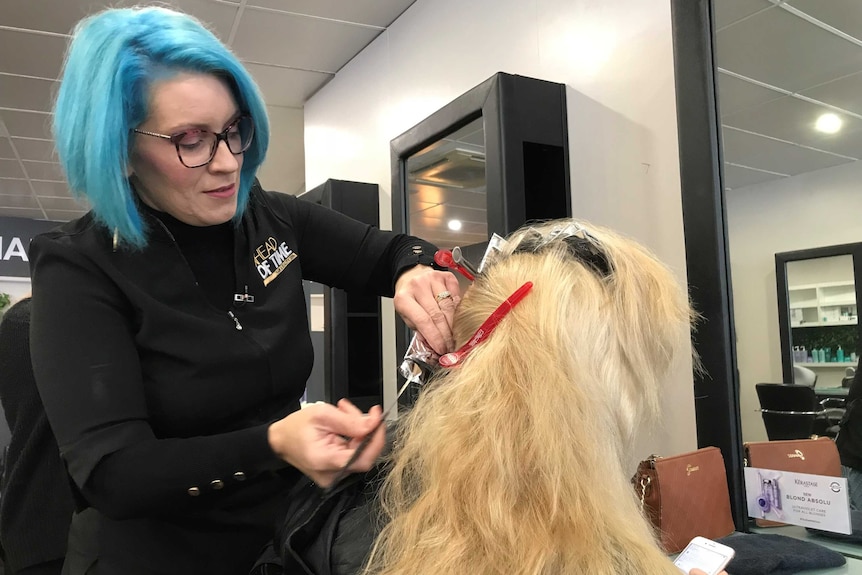 Anne Marie Ryan working on a customer's hair in her salon