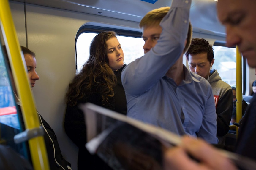 Student Molly Willmott stands on a crowded Melbourne train to get to university.