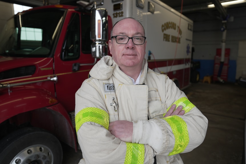 Fire chief Matt Sabo standing in front of a truck.