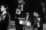 Tommie Smith (C) and John Carlos (R) raise their gloved fists