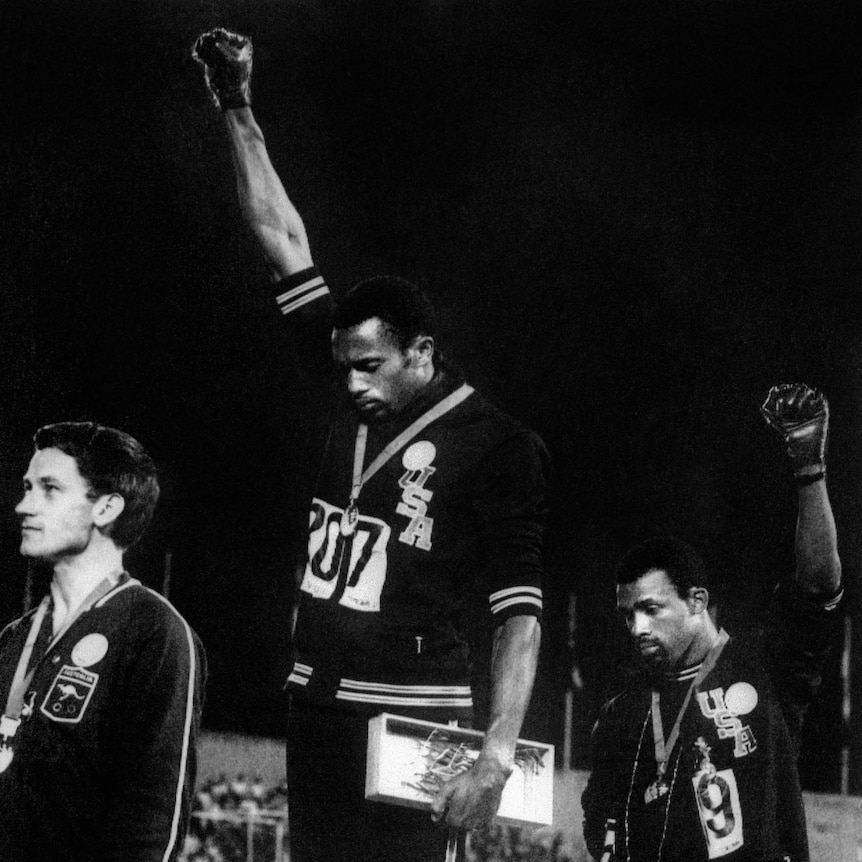 Historic moment ... Peter Norman (L) stands with Tommie Smith (C) and John Carlos on the medal podium in Mexico City