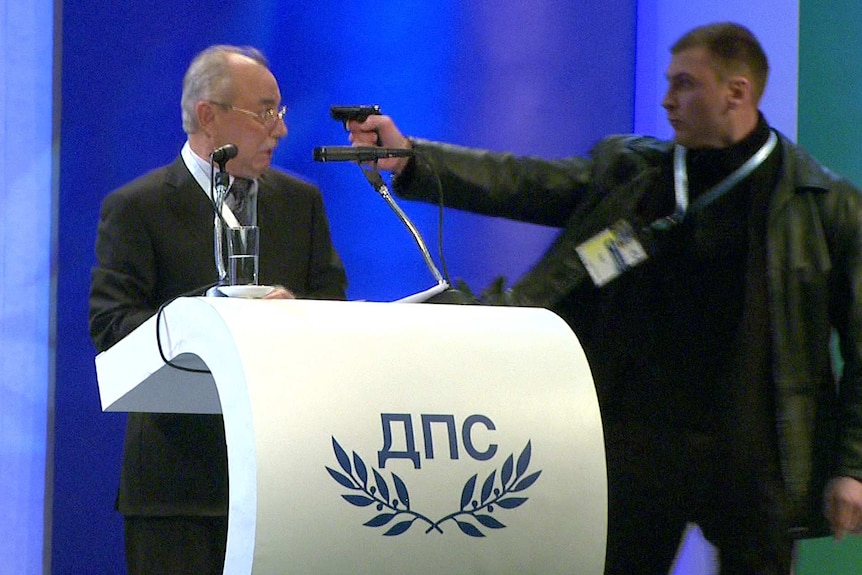 Video grab shows a man pointing a pistol at Bulgarian politician Ahmed Dogan.