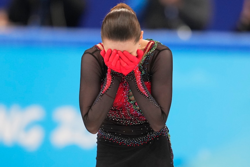 A Russian female figure skater with her hands on her face during a performance at 2022 Winter Olympics.
