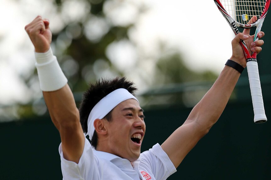 Kei Nishikori celebrates winning at Wimbledon