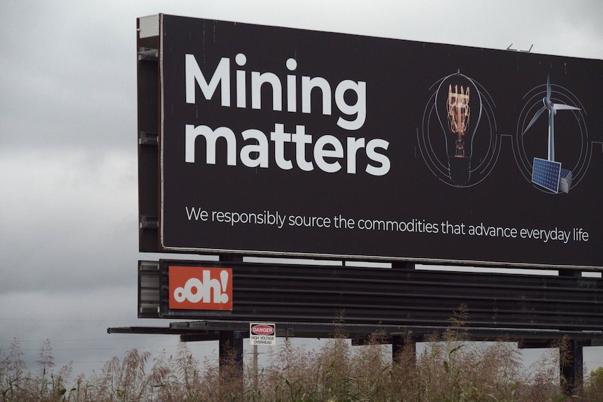 a roadside billboard reading "mining matters" in large letters