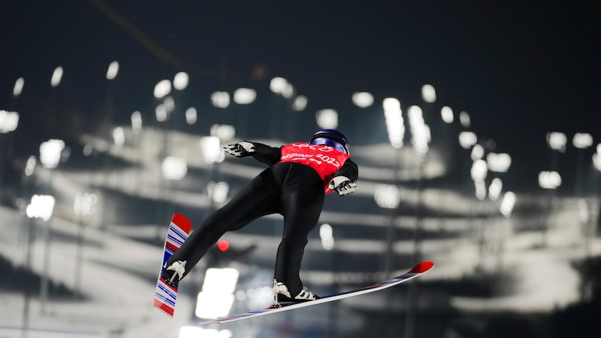 Ryoyu Kobayashi, of Japan can be seen from behind as he soars through the air in winter olympics training in Zhangjiakou,