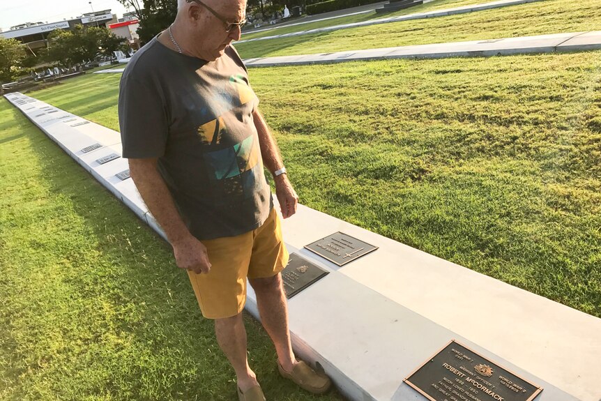 Robert Hazlewood stands near the new marked grave of Robert McCormack at the Lutwyche Cemetery.