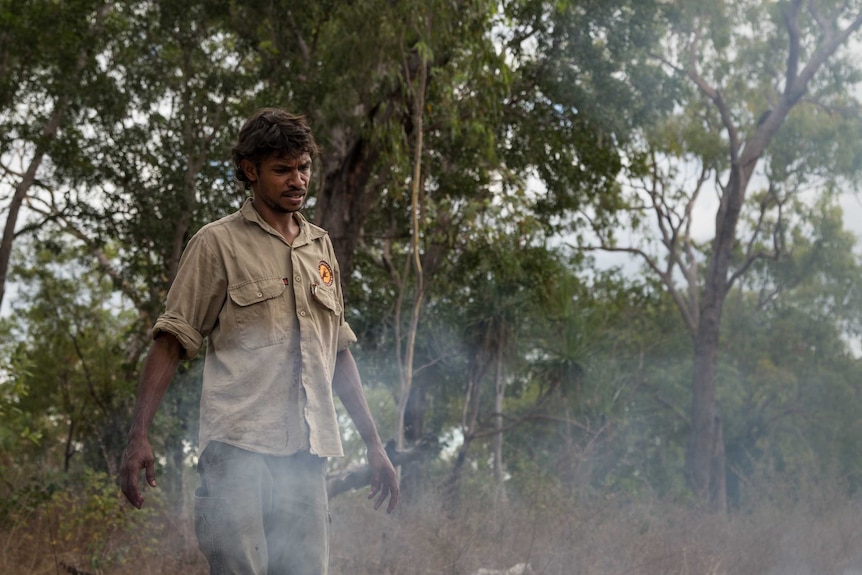 Warddeken ranger Lindsay Whitehurst squints in the smoke.