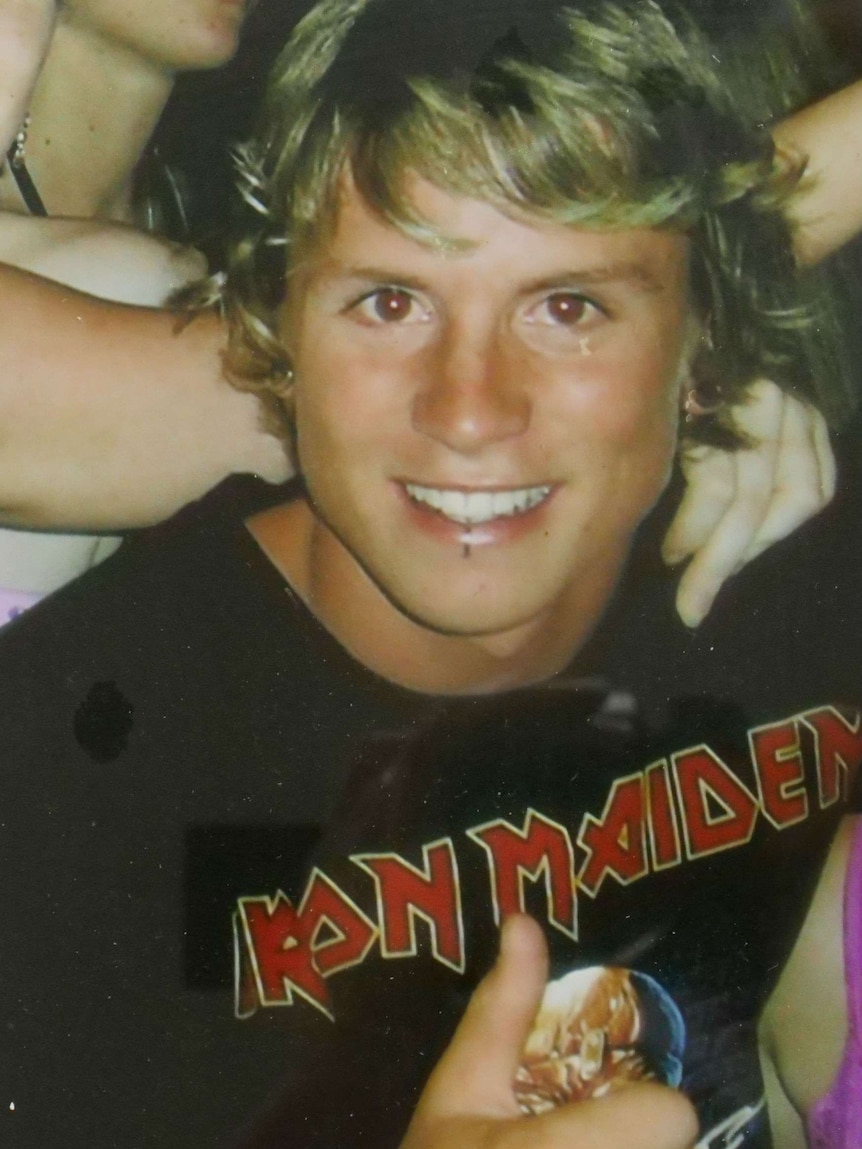 Ben Turner, a smiling blonde young man, in an Iron Maiden shirt.
