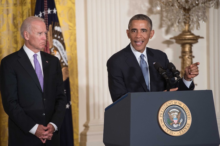 US Vice President Joe Biden looks on as President Barack Obama speaks