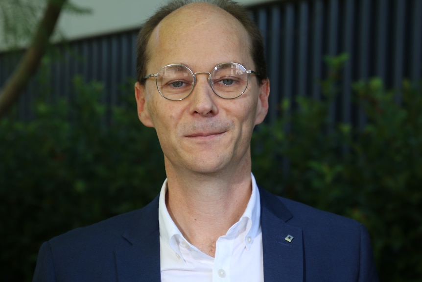 A man in a suit wearing glasses