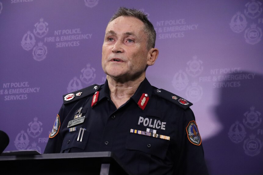 a man in police uniform speaking at a press conference