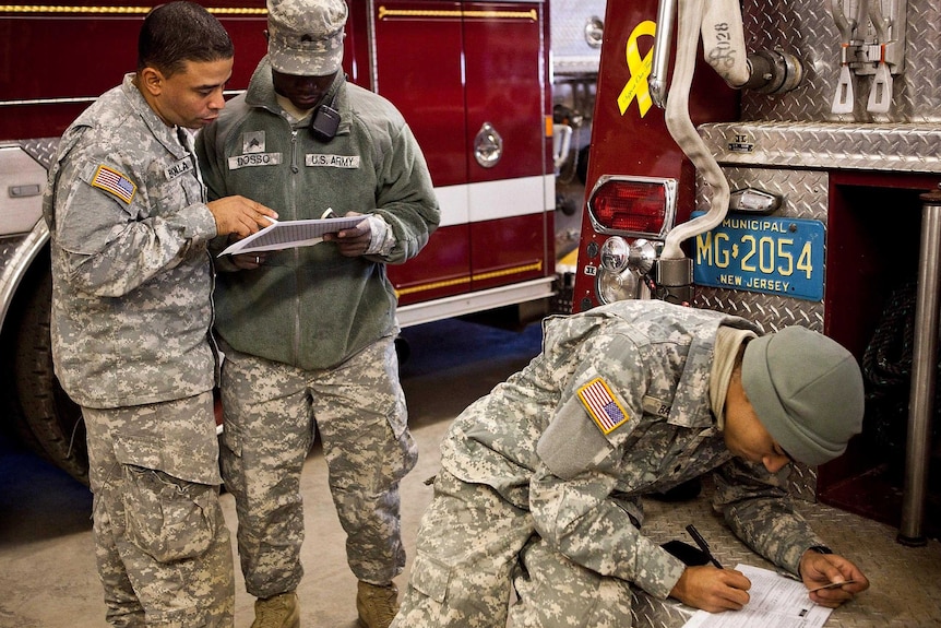 Members of the Army National Guard helping in the super storm Sandy clean-up along the New Jersey coastline cast absentee votes.