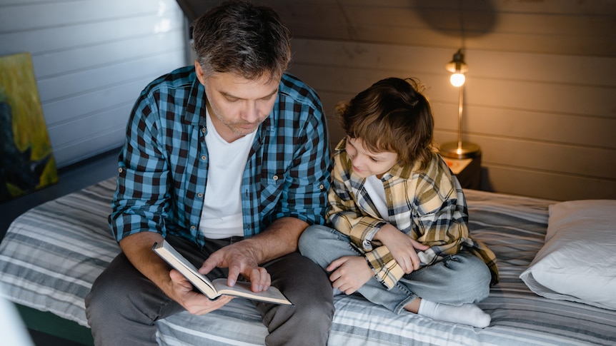 A parent reads out loud to a child