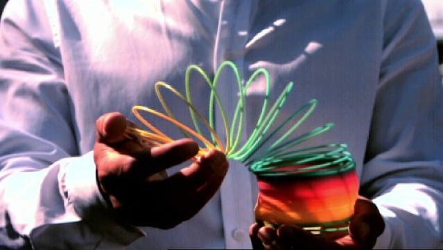 A hand holds a slinky