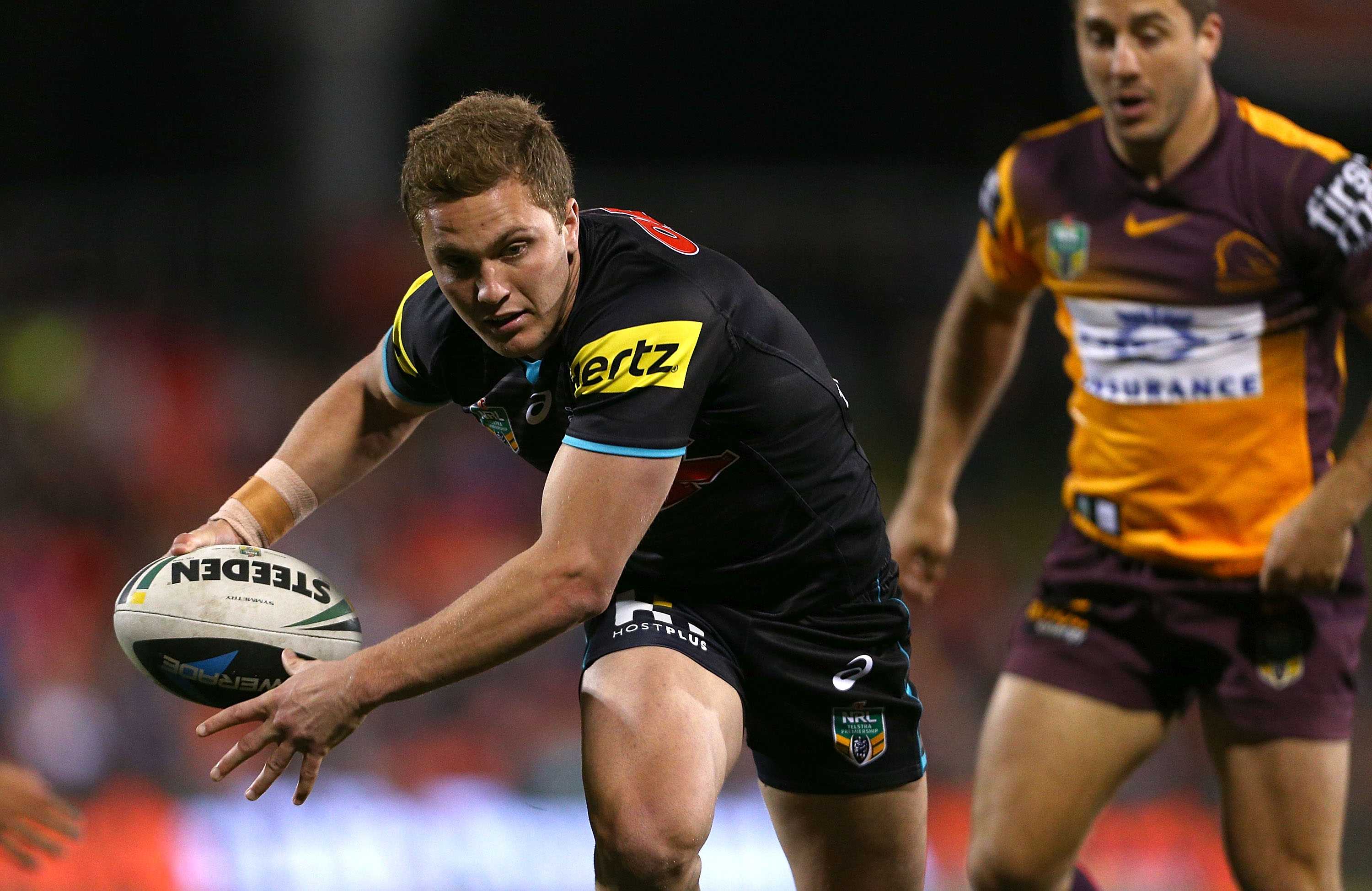 Penrith's Matt Moylan breaks the Broncos' line