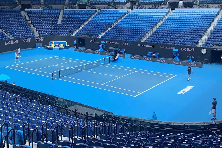 Tennis players practising at Rod Laver Arena.