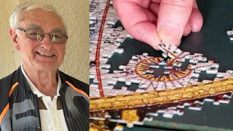 man with grey hair and spectacles smiling and close up of hand laying puzzle pieces in place