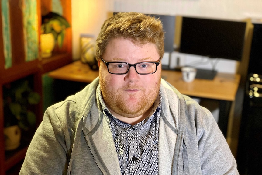 Tom Reynolds sits in a study and looks up at the camera.